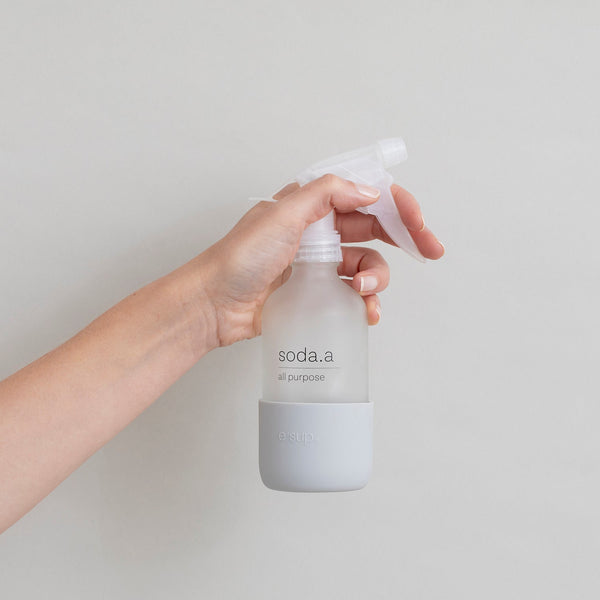 soda.a all-purpose reusable glass spray bottle held in hand