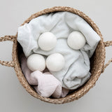 wool dryer balls in basket with towels