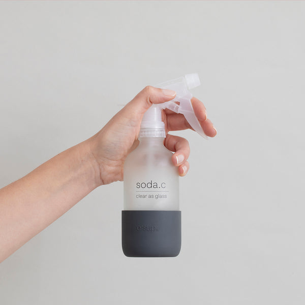 soda.c reusable glass spray bottle held in hand